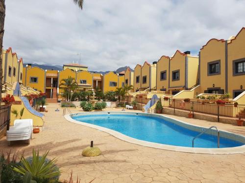 a swimming pool in the middle of a resort at Chalet Costa Adeje in Adeje