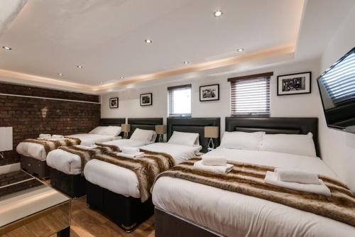 a room with a bunch of beds in it at The Picture House Apartments in Liverpool