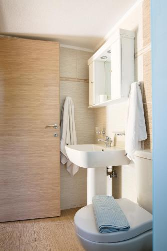 a bathroom with a white sink and a toilet at Villa Italiana in Agios Nikolaos
