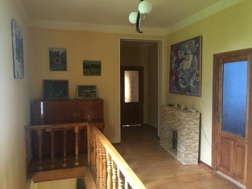 a hallway with a staircase and a fireplace in a house at Areguni Guest House in Dilijan