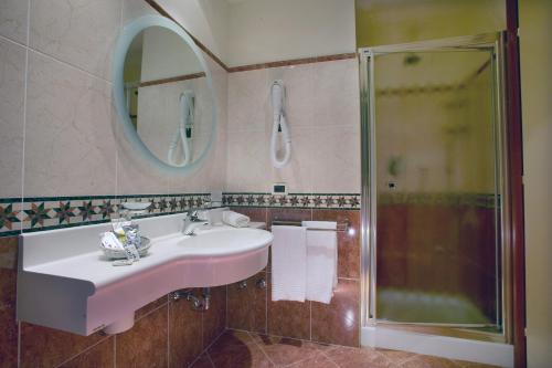 a bathroom with a sink and a shower at Hotel La Rondine in Sirmione