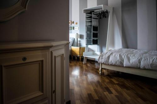 a bedroom with a bed and a wooden floor at B&B La Cuntana in Potenza