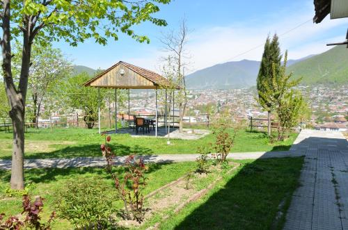a garden with a gazebo in a city at Sheki Panorama Guest House in Sheki