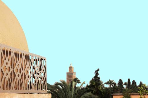 a view of a building with trees in the background at Palais d'hôtes Darsor in Marrakech