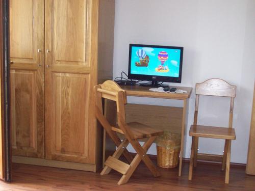 a desk with a computer and a chair in a room at House Mara in Korenica