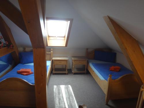 a attic room with two bunk beds and a window at Gasthof zur Schweiz in Jena