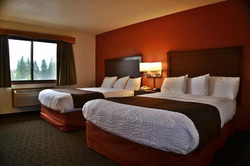 Ένα ή περισσότερα κρεβάτια σε δωμάτιο στο AmericInn by Wyndham Calumet
