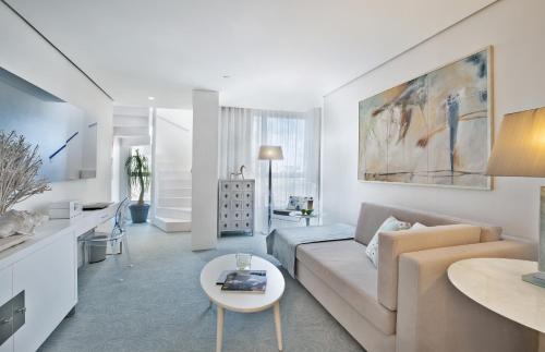 a living room with a couch and a table at Hotel White Lisboa in Lisbon