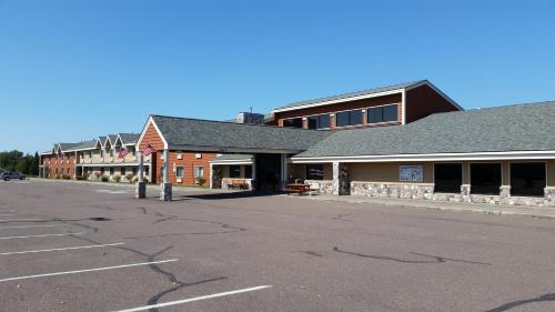 an empty parking lot in front of a building at AmericInn by Wyndham Calumet in Calumet