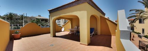 a balcony of a house with a table on it at Chalet Costa Adeje in Adeje