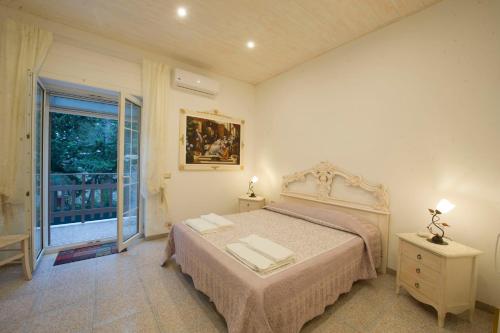a bedroom with a bed and a large window at La Cutizza B&B in Martina Franca
