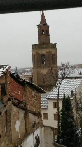 an old building with a clock tower in a city at Hostal Pirineos in Barbastro