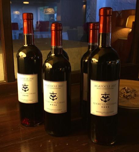 three bottles of wine sitting on a table at Resort Le Picchiaie in Portoferraio