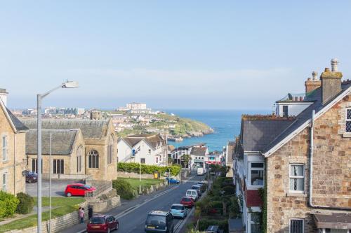 a city street with houses and the ocean at The Glendeveor in Newquay