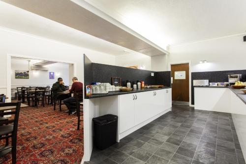 a restaurant with a counter and people sitting at tables at The Glendeveor in Newquay