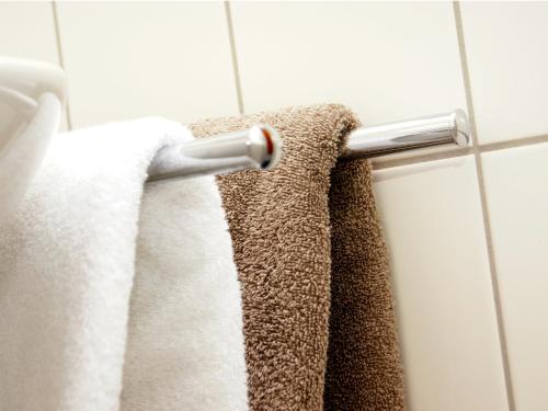 a towel rack in a bathroom with white towels at Börse Coswig in Coswig