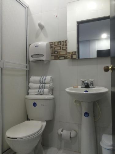 a bathroom with a toilet and a sink at Hotel Sunset Beach in Cartagena de Indias