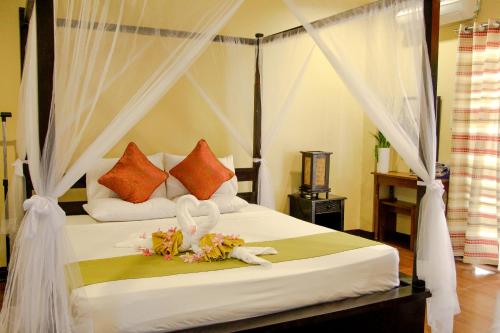 Sulu Sea Boutique Hotel tesisinde bir odada yatak veya yataklar
