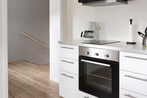 a kitchen with white counters and a black oven at Casablanca Apartments in Keflavík