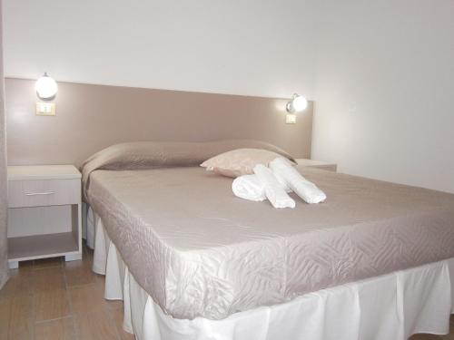a bedroom with a bed with two towels on it at Appartamenti Da Nicola in Lampedusa