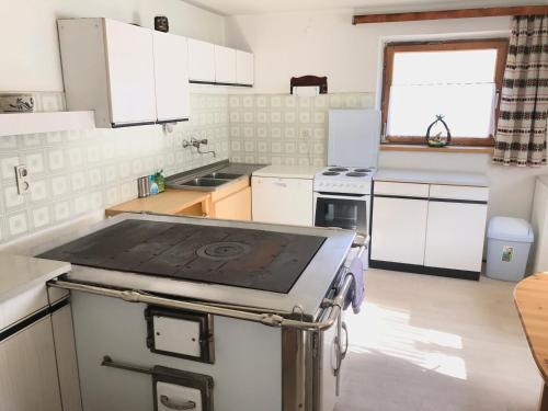 a kitchen with a stove top oven in a room at Haus Leng in Heiligenblut