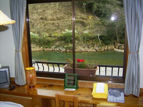 a window with a view of a river at Ashita no Mori in Hongu
