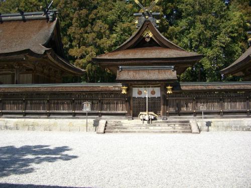 a pagoda with a building with stairs in front at Ashita no Mori in Hongu