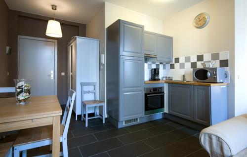 a small kitchen with a table and a refrigerator at Appartbrussels in Brussels