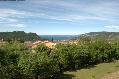 a view of a town with trees and a body of water at Villa Benvenuto in Costermano sul Garda