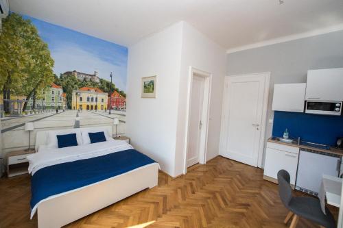 a bedroom with a bed with a painting on the wall at B&B Vila Teslova in Ljubljana