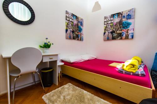 a bedroom with a bed with a teddy bear on it at Crazy House Hostel in Pula