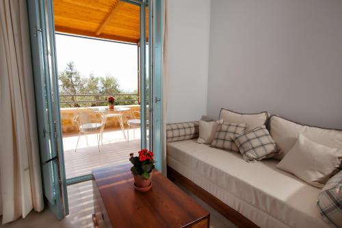 a living room with a couch and a table at Lithos Guesthouse Kardamili in Kardamili