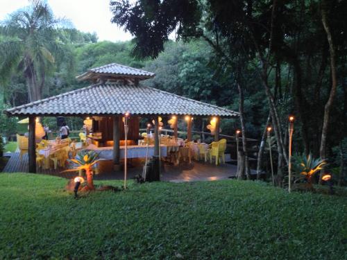 a gazebo with a restaurant in a park at Pousada Esperança in Osório