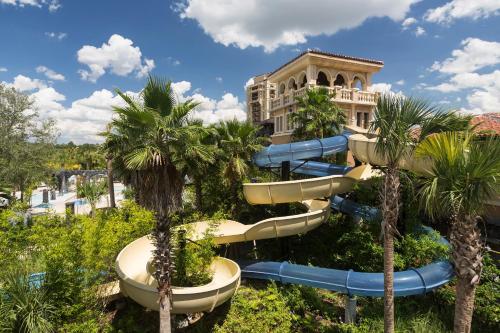 a water slide at a resort with palm trees at Four Seasons Resort Orlando at Walt Disney World Resort in Orlando