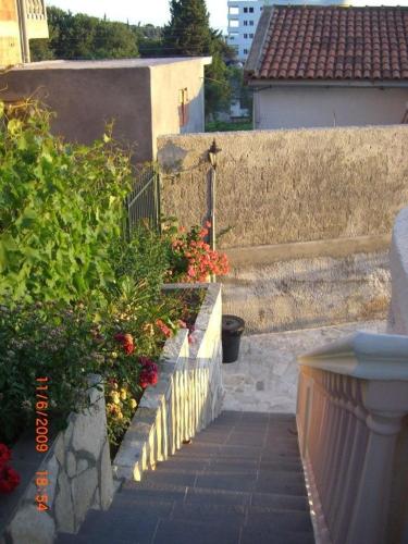 a set of stairs leading to a house with flowers at Villa Beba in Dobra Voda