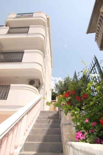a stairway leading up to a building with flowers at Villa Beba in Dobra Voda