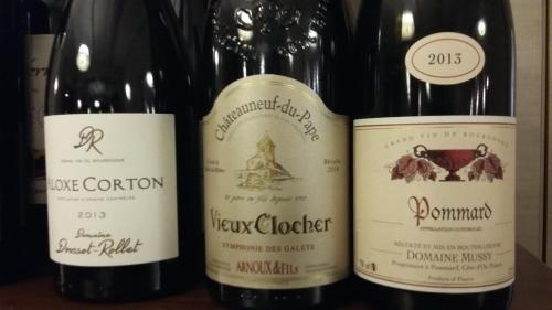 three bottles of wine sitting on a shelf at Auberge du château de Joux in La Cluse et Mijoux