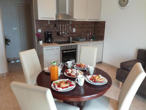 a table with plates of food on it in a kitchen at Apartment Ariana in Bol