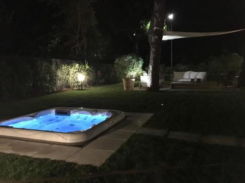 una bañera de hidromasaje en un patio por la noche en Provenzale, en Desenzano del Garda