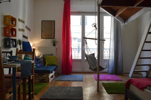 a living room with a bed and a couch and a window at Pulse Life Budapest Centre in Budapest