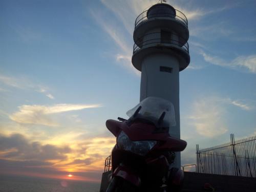 a light house with a lighthouse in the background at Casa das Fiadeiras de Nemiña con Jacuzzi in Nemiña