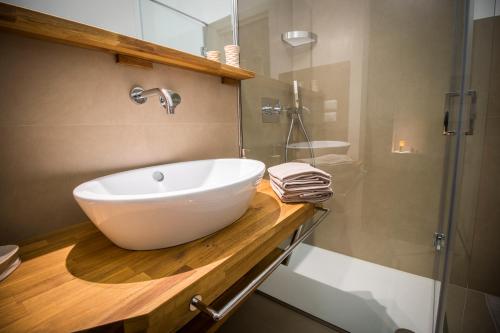 a bathroom with a white sink and a shower at Il Paradiso a Claustro Inferno in Altamura