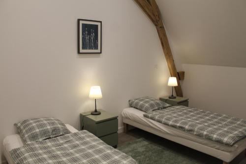 מיטה או מיטות בחדר ב-Le Presbytère