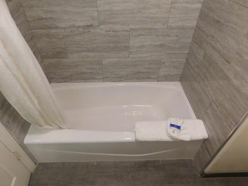 a bathroom with a bath tub with a towel at Fisherman's Cove Inn in Monterey