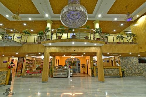 a large lobby with a large chandelier in a building at The Grand Mamta in Srinagar