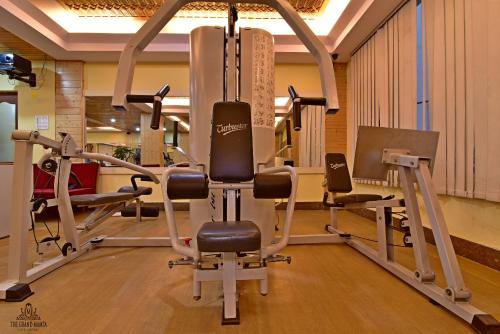a gym with several treadmills and a treadmill at The Grand Mamta in Srinagar