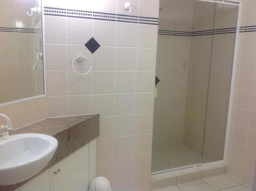a bathroom with a sink and a shower at Kings Row Apartments in Caloundra