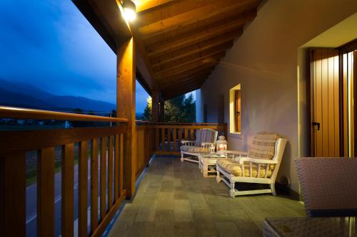 a balcony with chairs and a table on it at Albergo Diffuso Polcenigo B.Vittorio in Polcenigo