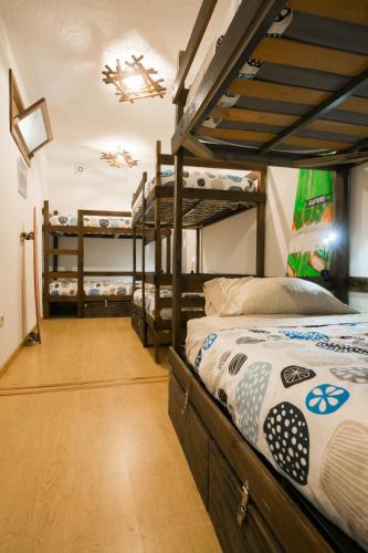 a room with several bunk beds in a room at Douro Surf Hostel in Vila Nova de Gaia