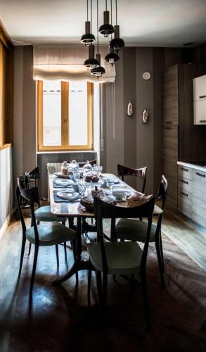 a dining room table and chairs in a room at B&B La Cuntana in Potenza